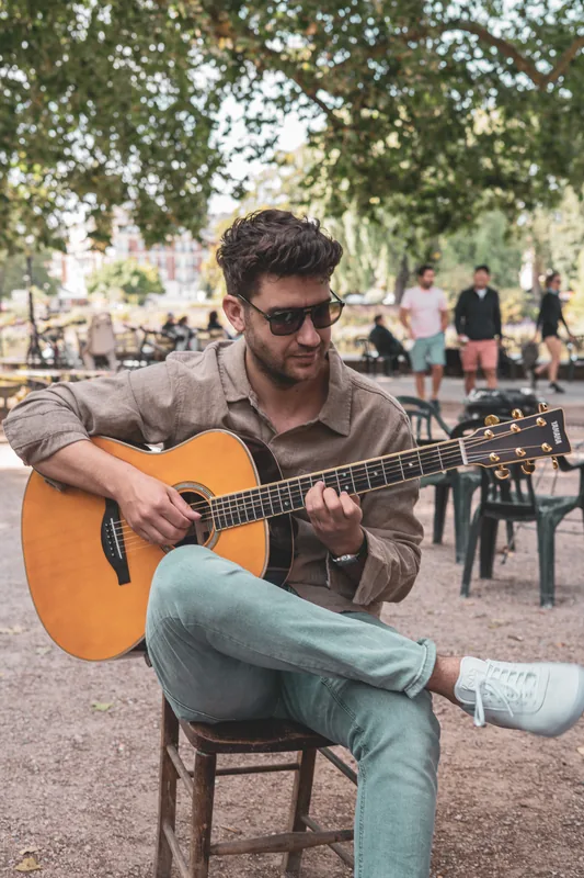 Balazs, guitar teacher in Colchester, playing acoustic guitar